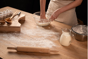 Person kneading dough for baking, a Food & Drink Photo by volodymyrshtun13795