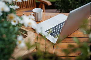 Laptop on wooden garden table in, a Technology Photo by HalfPoint