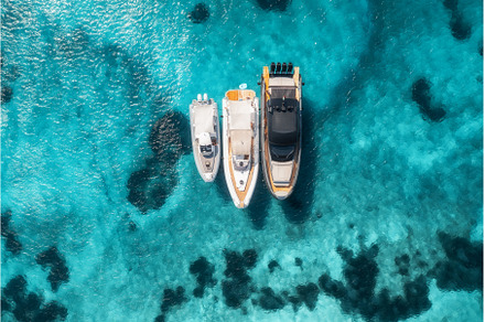 Aerial view of three yachts on, a Nature Photo by den-belitsky