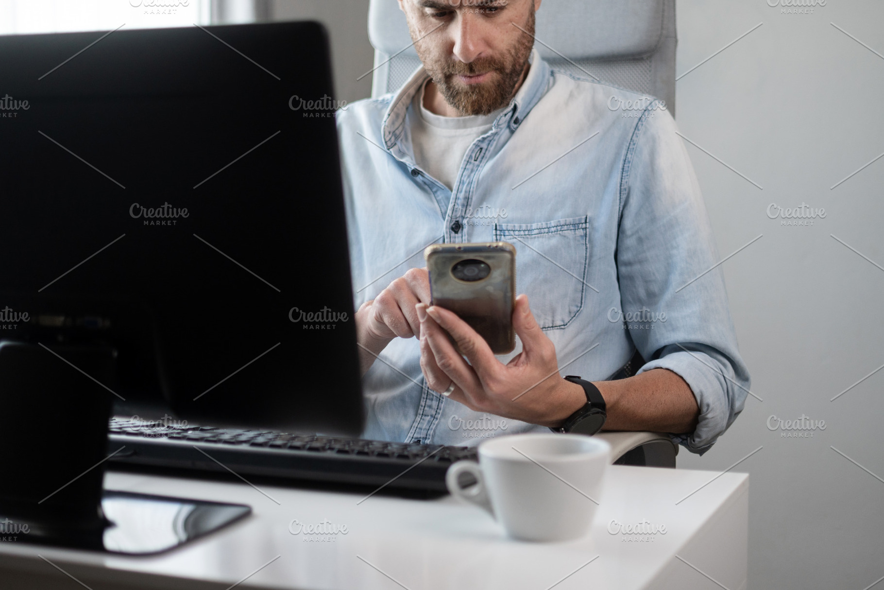 Man using smartphone while working at desk in home office, a Person Photo by etorres69