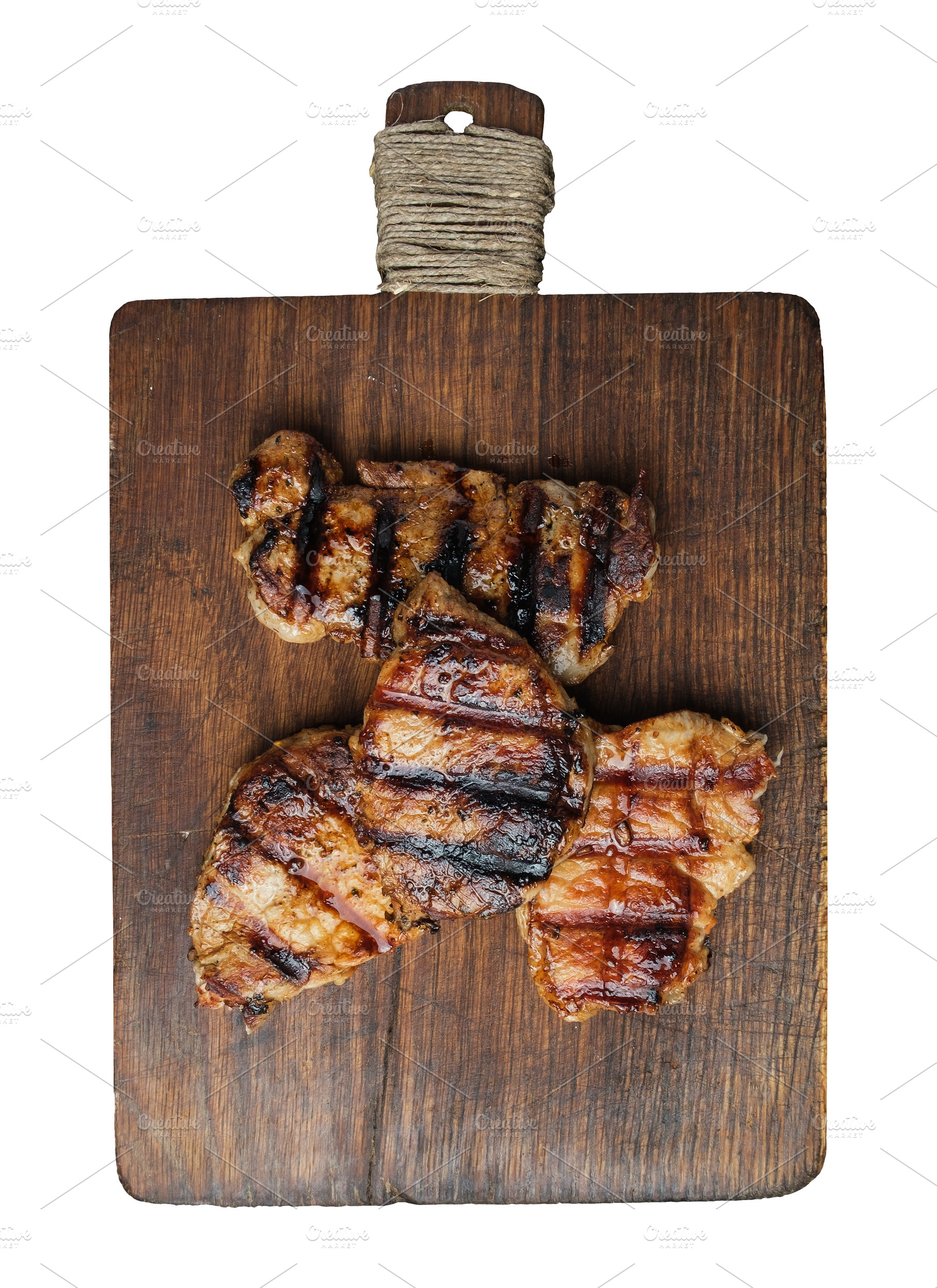 Three grilled steaks on a wooden board, isolated background, a Food & Drink Photo by ndanko