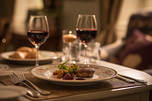 Romantic fine dining setting with gourmet meal and red wine glasses at an elega, a Food & Drink Photo by Studio ANNA