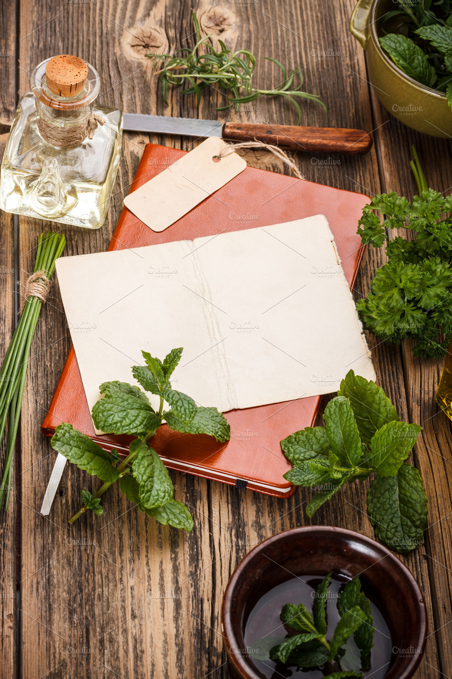 Fresh herbs containing herb, book, and paper