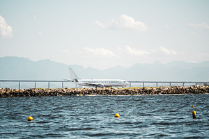 Airplane by coast in telephoto view, a Transportation Photo by SkyNext
