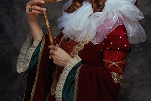 medieval queen in red dress with venetian mask, a Person Photo by Alliance Images