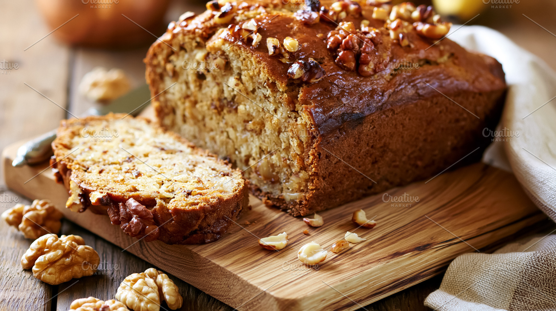 Banana walnut bread loaf with a fresh slice and scattered nuts, a sweet homemad, a Photo by Studio ANNA