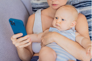 Baby sitting on mother lap while she, a Person Photo by Elizaveta Galitskaya