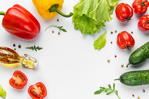 Fresh vegetables and olive oil creating a healthy food border, a Food & Drink Photo by Olena Rudo