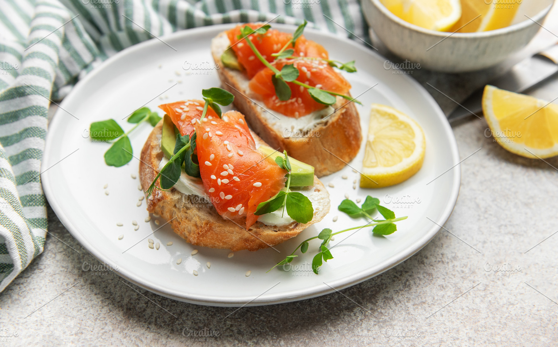 Smoked salmon bruschetta with cream cheese and avocado, a Photo by Olena Rudo
