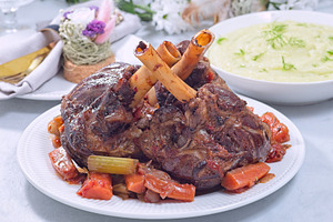 Delicious braised lamb shanks with vegetables served on a white plate, horizont, a Food & Drink Photo by iuliia_n
