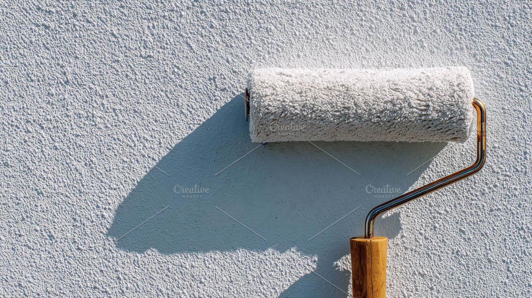 Painting a wall with a roller, a Photo by Beautiful things