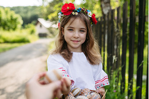 Young girl holding traditionally, a Holiday Photo by HalfPoint
