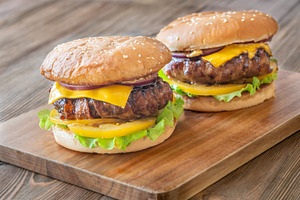 Two cheeseburgers with bacon, a Food & Drink Photo by Alexander Prokopenko
