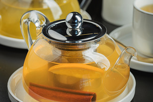 Fruit tea with mango and mint in a glass teapot on the table, a Food & Drink Photo by Budarinphoto