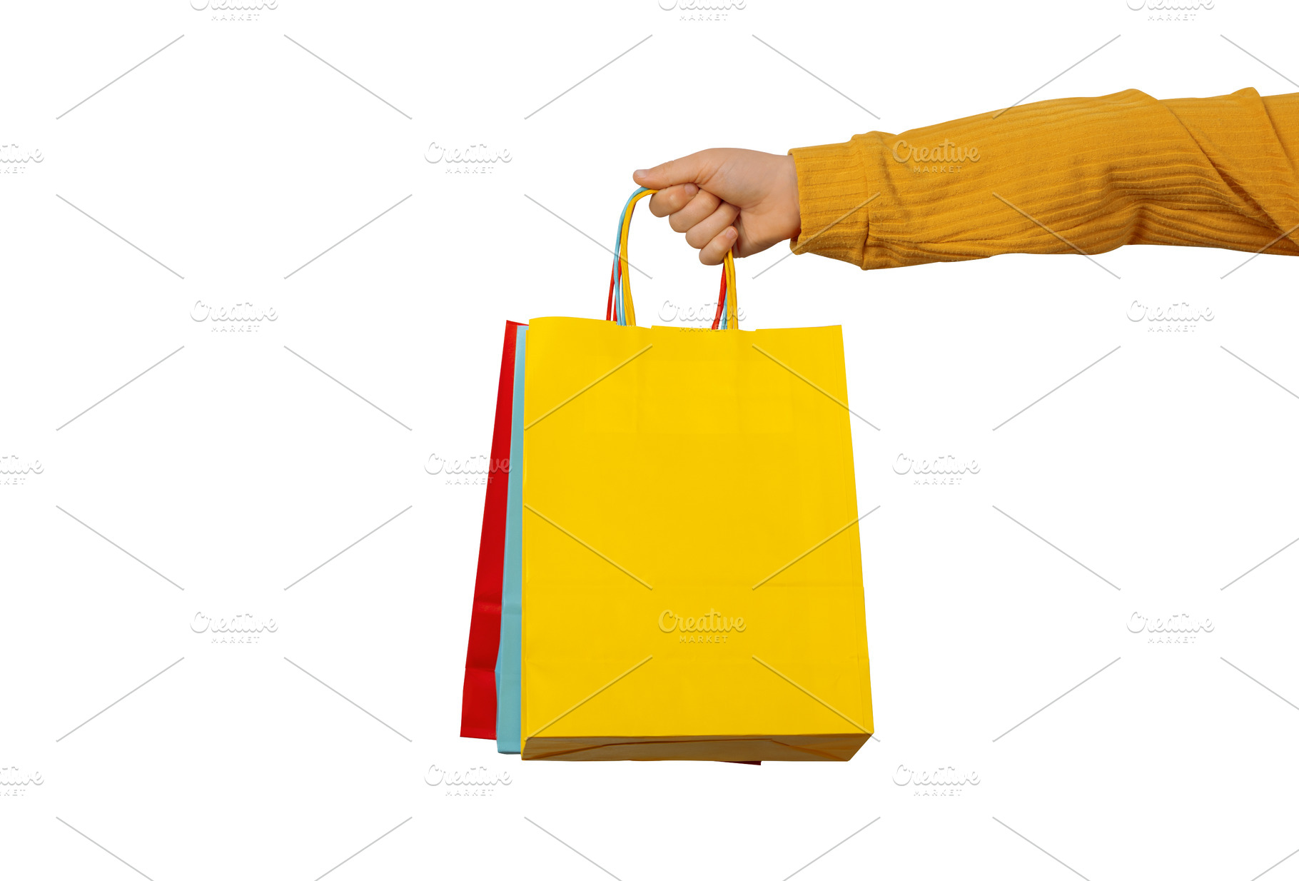 Close-up of a hand holding bright shopping bags on a white backg, a Holiday Photo by Ales Munt