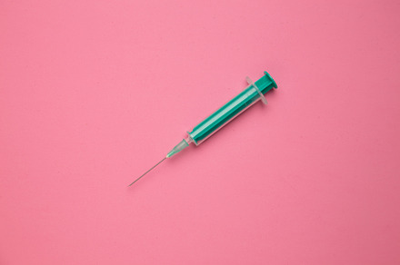 Medical syringe on colorful backgrou