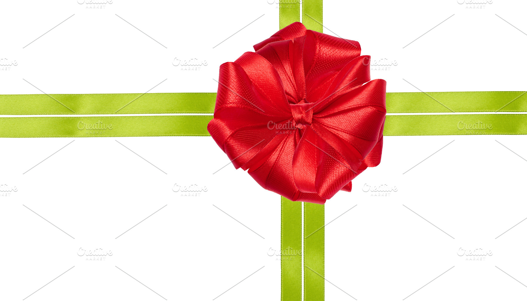 A bright red bow is placed in the center of a composition of two, a Holiday Photo by ndanko