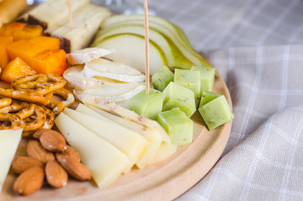 Cheese plates served with grapes, jam, snacks, crackers and nuts, a Food & Drink Photo by vimart