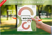 Outdoor Hand Held Paper Mockup PSD, a Product Mockup by Bruno's Shop (Thumbnail 1 of 4)