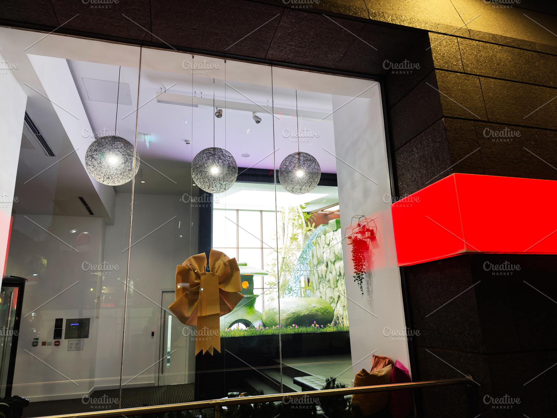 Bright modern store window in Manchester featuring a large gold bow and decorat, a Photo by AS photostudio