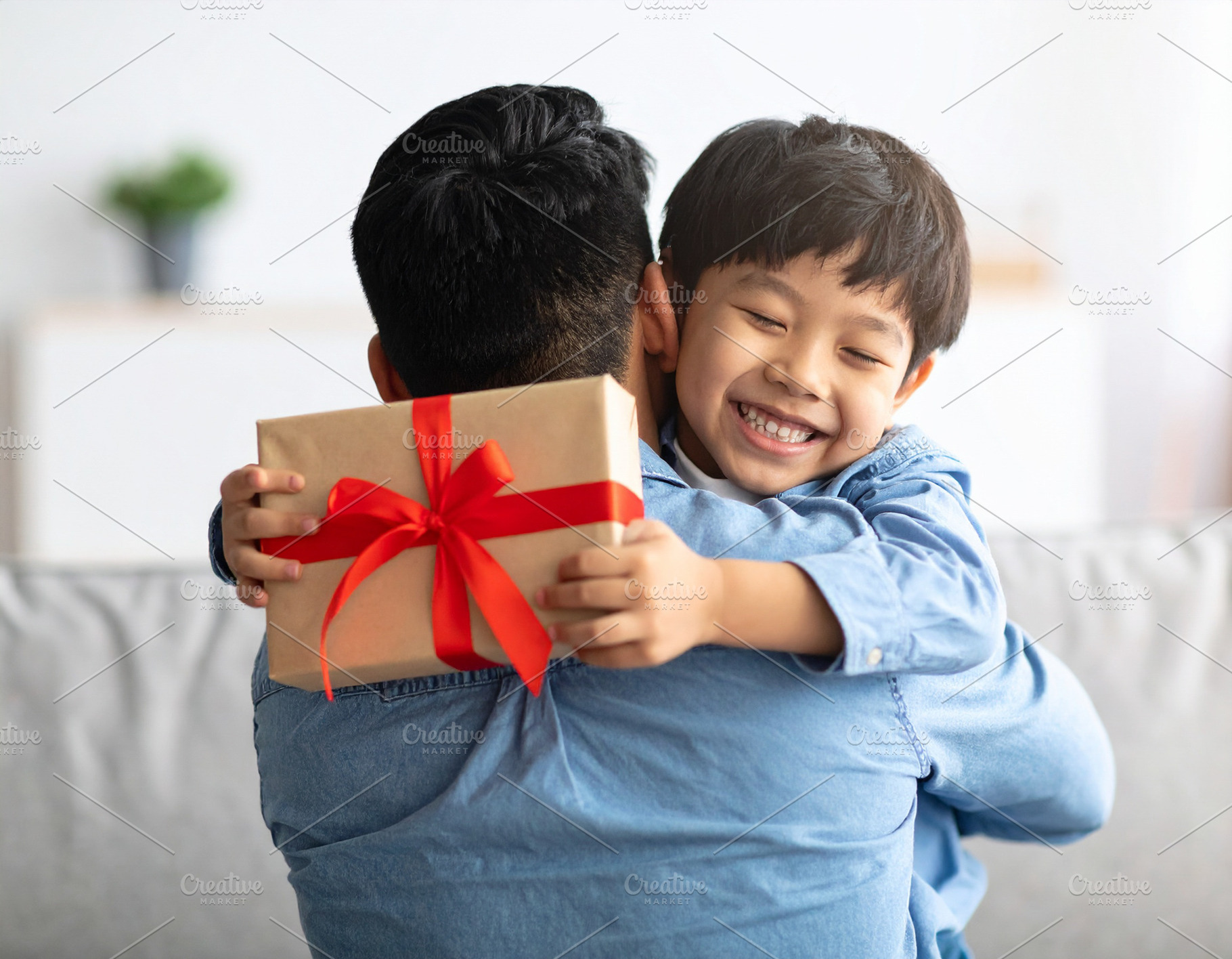 Father hugging his child after receiving a handmade fathers day, a Person Photo by DanFLCreativo