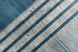 Abstract concrete surface with shadows, an Abstract Photo by AlyaAnd
