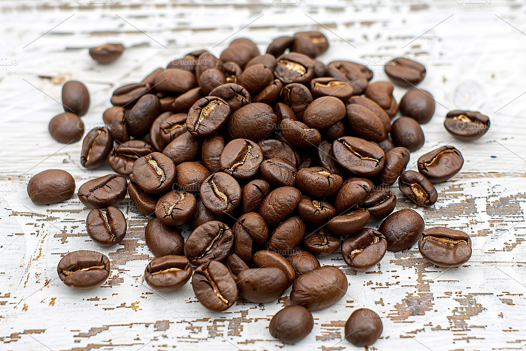 Heap of coffee beans on wooden table, a Food & Drink Photo by AlyaAnd