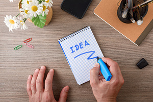 Writing Business Idea on Notepad at Desk, a Business Photo by Davizro's Market