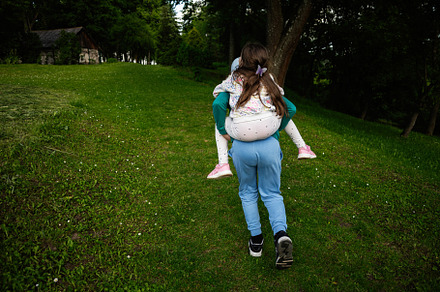 Two Kids Playing Outdoors in a Green Forest Area on a Summer Day, a Person Photo by AS photostudio