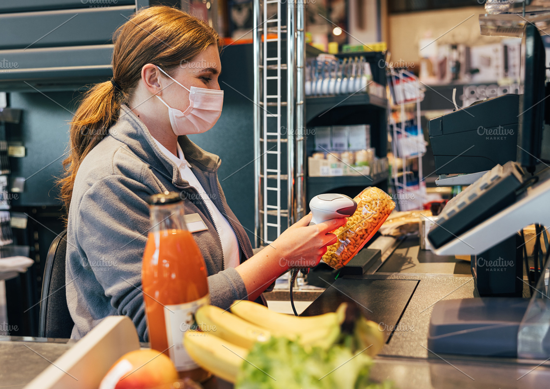 Female cashier in mask using barcode, a Person Photo by Artem Varnitsin