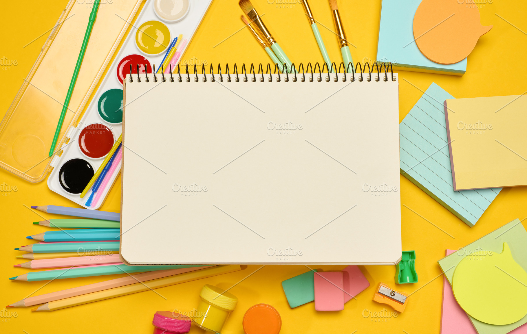 Open blank spiral notebook in the center, surrounded by school s, a School & Education Photo by ndanko