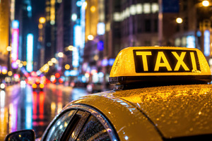 Bright taxi in city at night, a Photo by Beautiful things