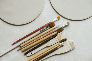 Ceramics in pottery workshop set featuring tools, pottery, and glaze, an Arts & Entertainment Photo by Julia Ether