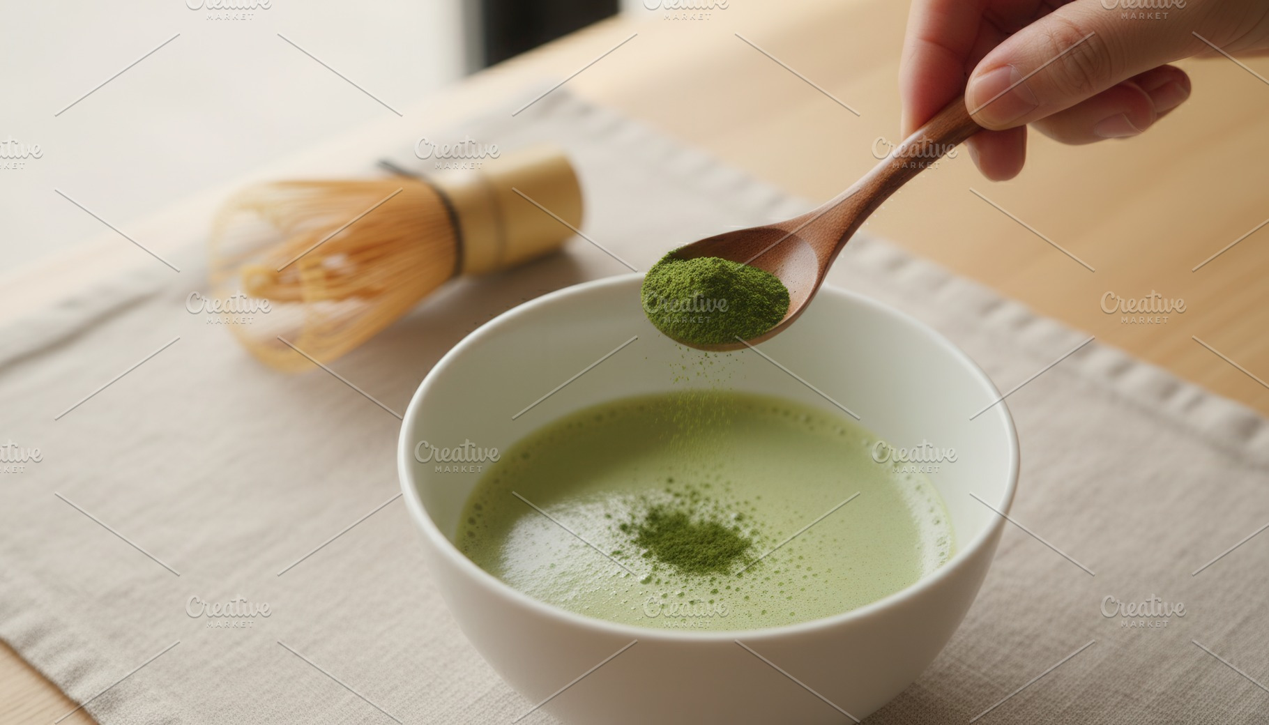 Ceremonial matcha powder dusted over whisked tea, a Food & Drink Photo by Igor Tichonow