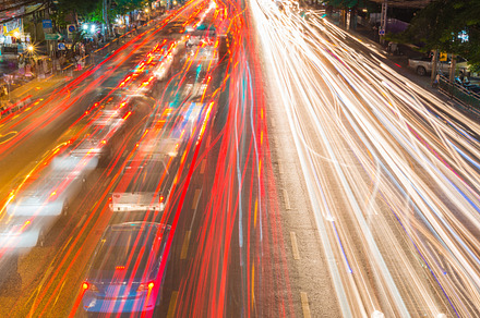 Light streams from ongoing traffic featuring traffic, light, and street, a Transportation Photo by Casanowe-studio