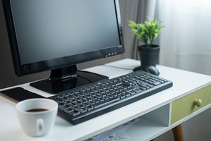 Modern home office desk with computer and coffee cup, a Person Photo by etorres69
