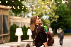 Young woman enjoying coffee outdoors, a Person Photo by Elena Vagengeim