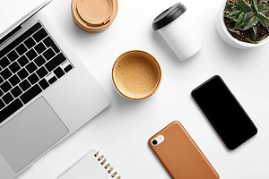 Workspace setup featuring a laptop, coffee, and smartphone during a productive, a Business Photo by AlyaAnd