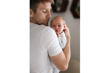 Father holding his newborn son at, a Person Photo by HalfPoint