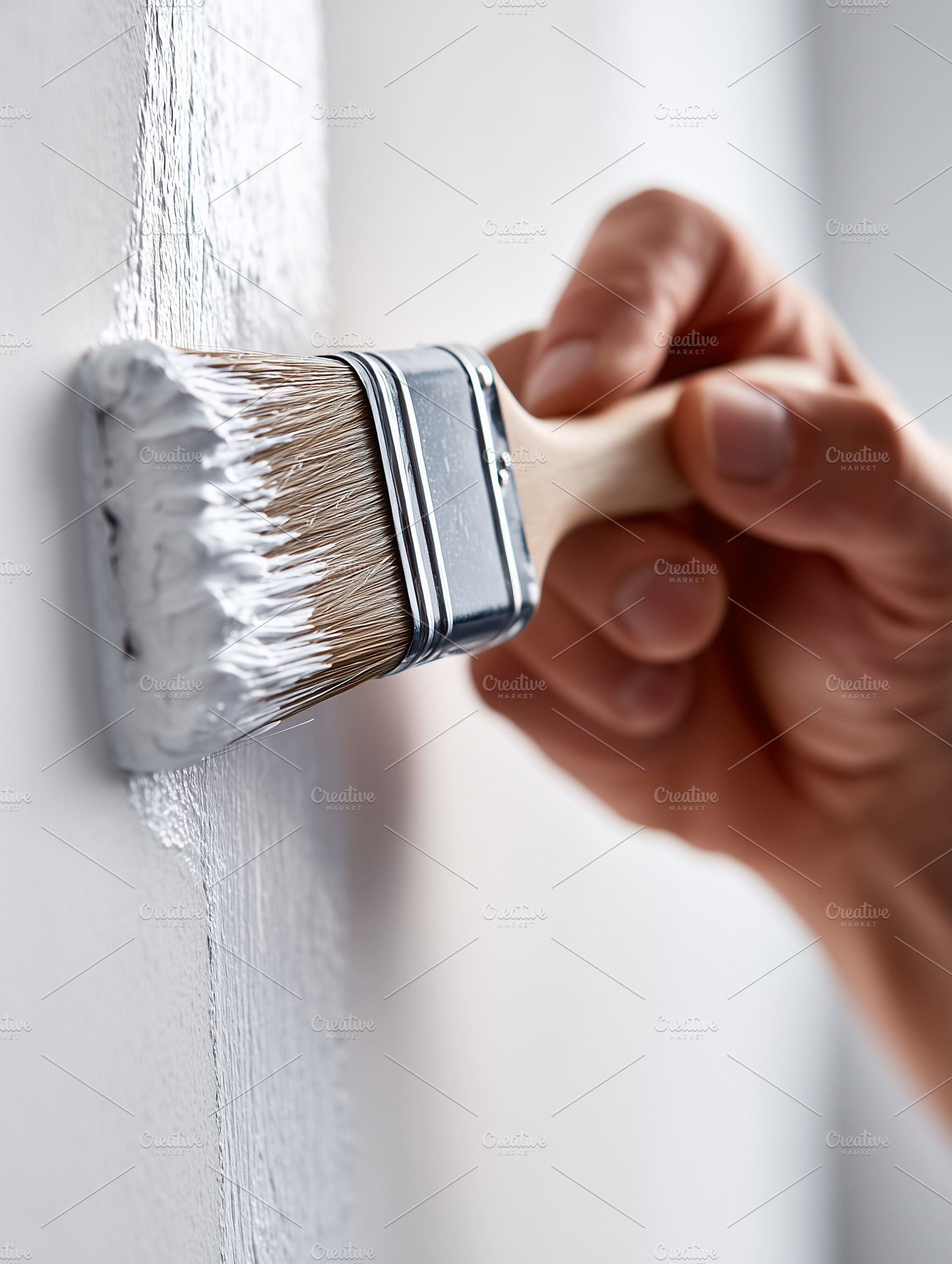 Close up of a hand using paintbrush, an Architecture Photo by MistyDay
