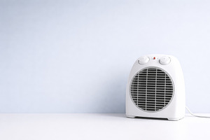 Electric heater on white table with, a Photo by Dvoevnore photos