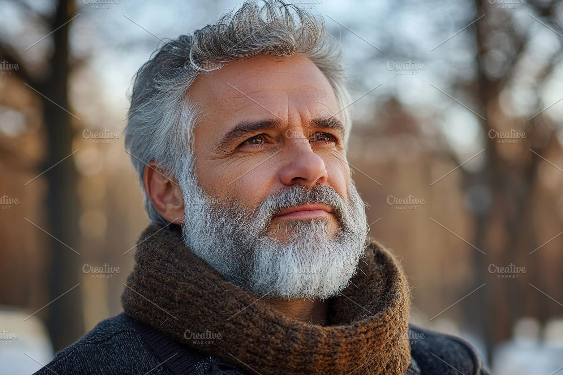 Mature man with gray hair gazes thoughtfully into the distance on a winter day, a Person Photo by AlyaAnd