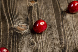 wet red cherry fruits on the kitchen table closeup, The berries are scattered o, a Photo by rsoollAI