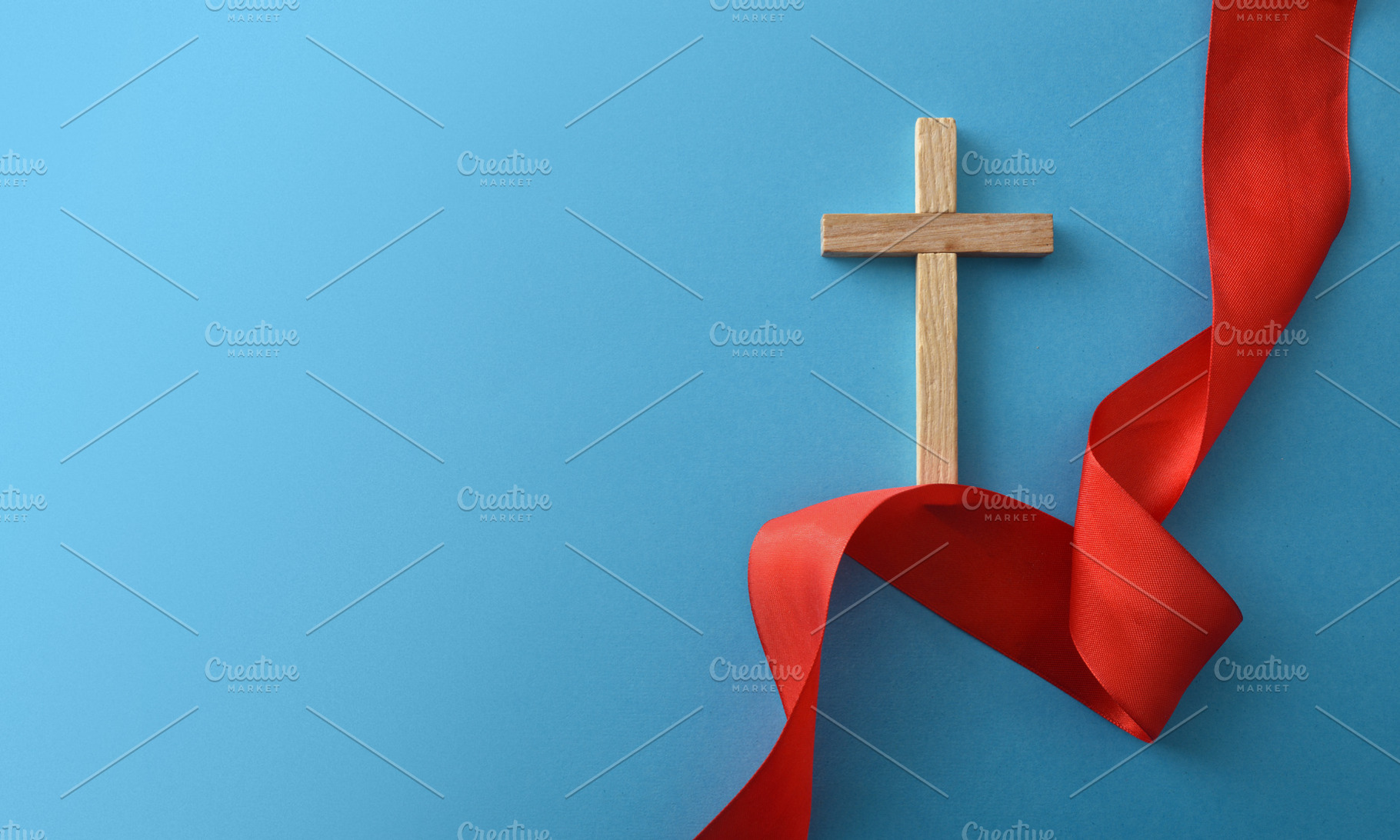 Wooden Cross with Red Ribbon on Blue Background, a Holiday Photo by Davizro's Market