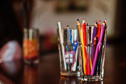 Pencils in glass for drawing on a table., a Background Photo by AS photostudio