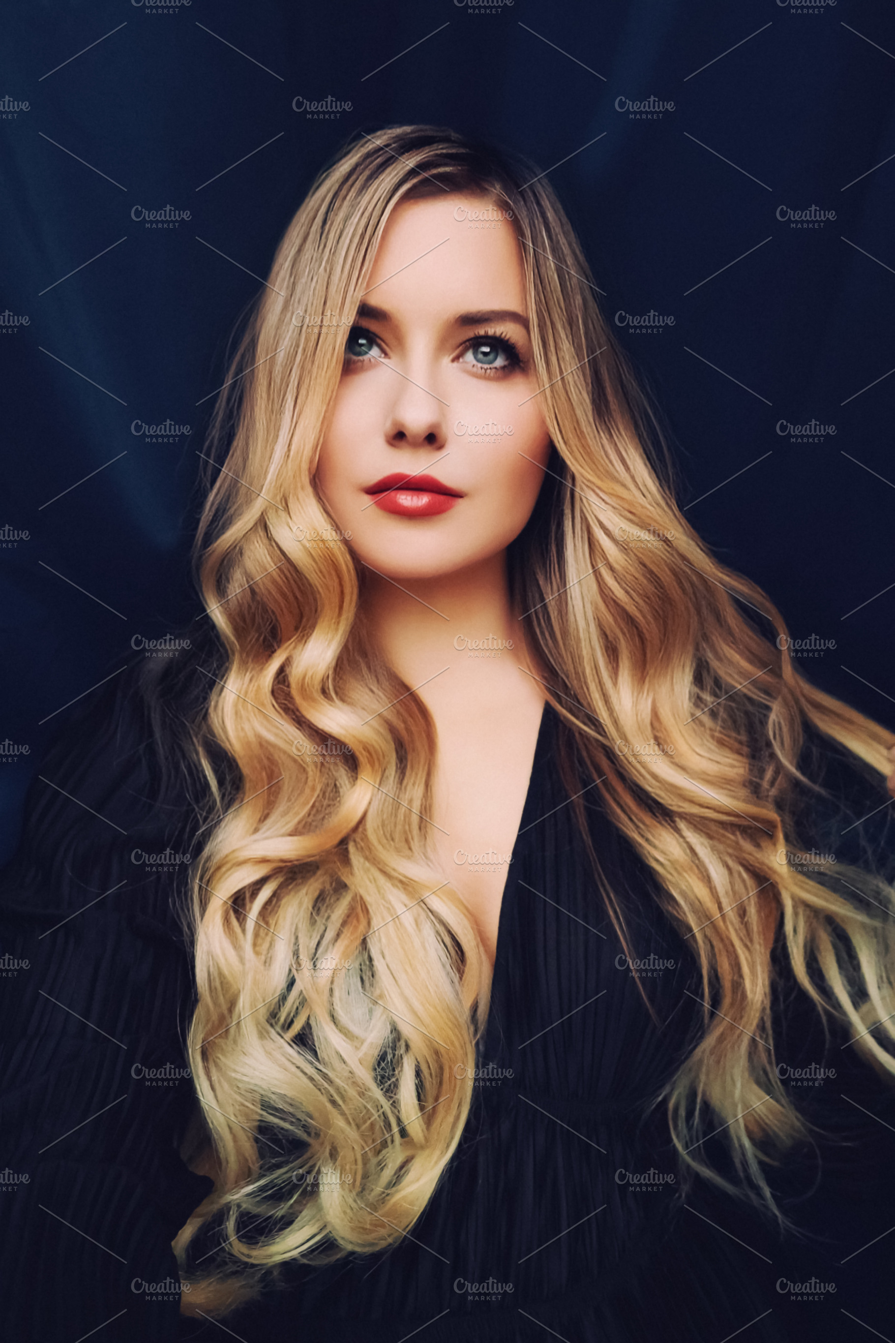 Young woman with long wavy blonde hair, blue eyes, and red lipst, a Person Photo by Anneleven