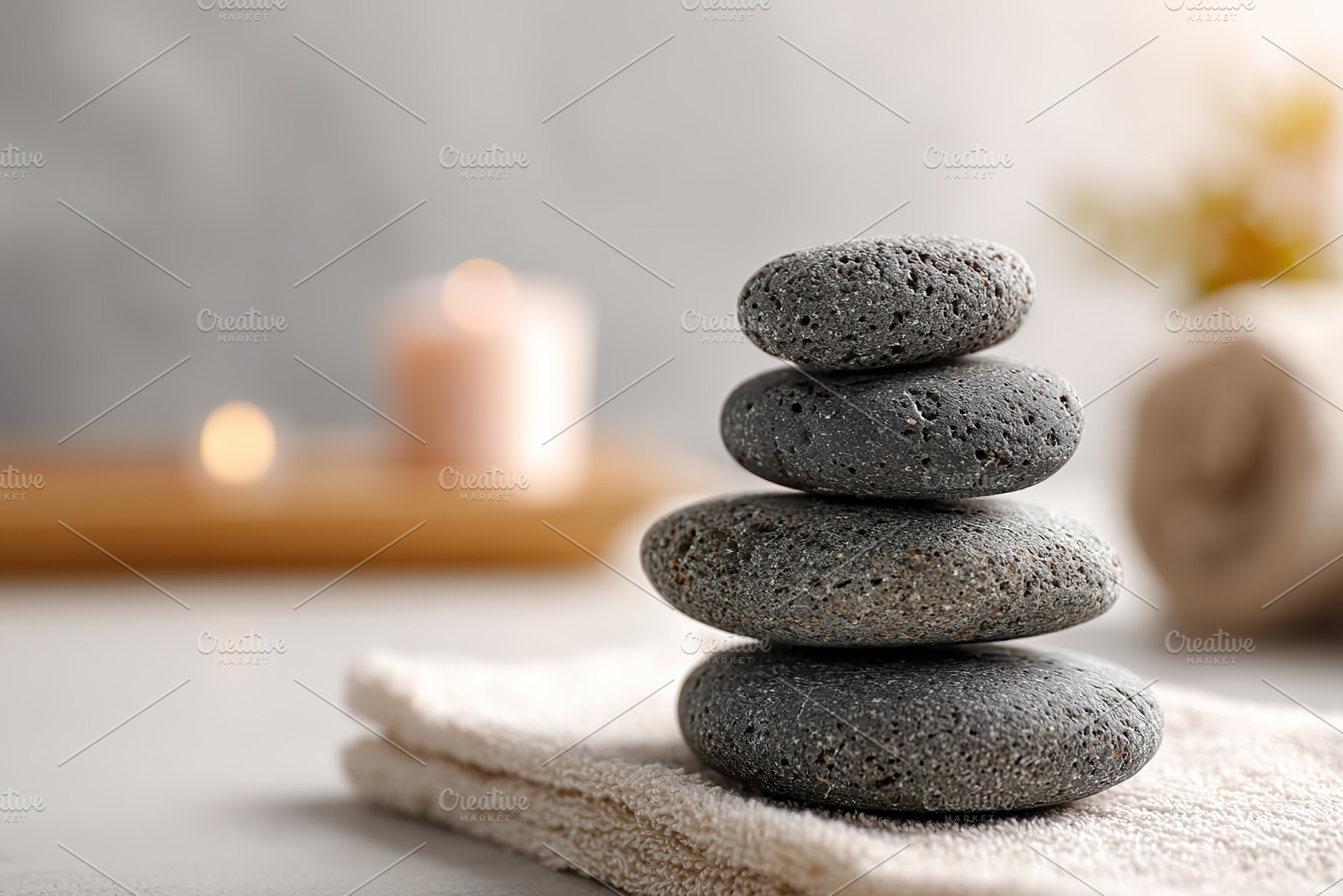 Balanced stones in a tranquil spa setting with soft lighting and soothing atmos, a Photo by AlyaAnd