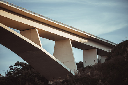 Minimalist concrete bridge at sunset, an Architecture Photo by SkyNext