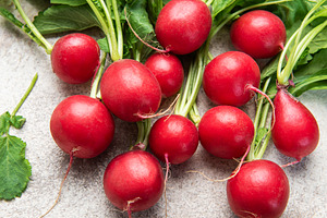Fresh red radish with green leaves on kitchen counter, a Food & Drink Photo by Olena Rudo