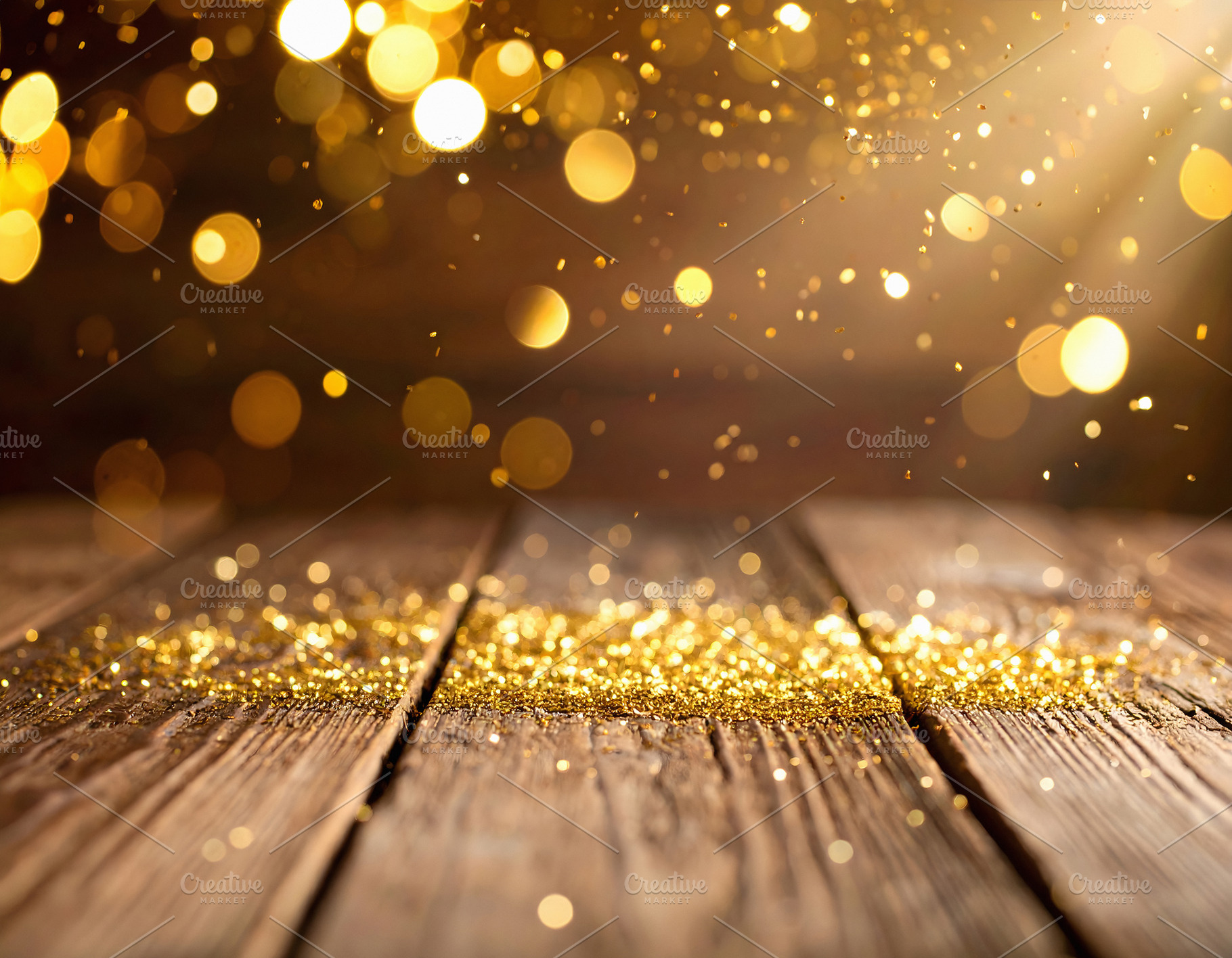 Golden sparkles scattered across wooden table in festive light, a Holiday Photo by GoodGoods